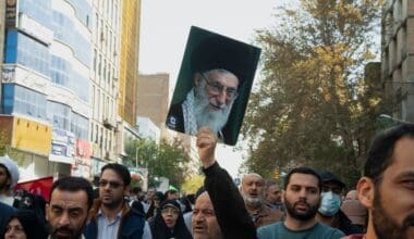 Tehran Iran - November 4, 2022, opposition march against America. A man holding a photo of Ayatollah Khamenei. A man who supports the leader of the Islamic Republic of Iran