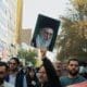 Tehran Iran - November 4, 2022, opposition march against America. A man holding a photo of Ayatollah Khamenei. A man who supports the leader of the Islamic Republic of Iran