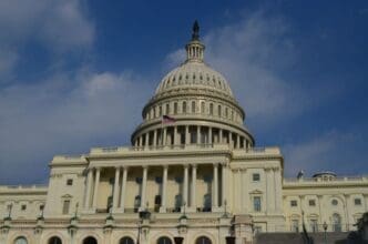 The American flag waving atop the Capitol Building in Washington, D.C