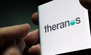 Theranos company logo seen on smartphone screen hold in hand. Stafford, United Kingdom, November 21, 2021