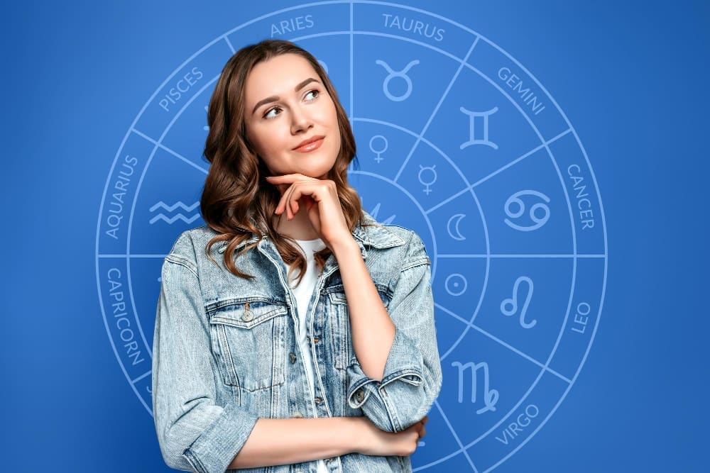 Thoughtful young woman set against the backdrop of a zodiac circle, representing astrology