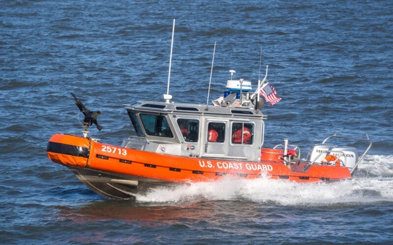 U.S. Coast Guard boat protect Ferry in navigation from Manhattan to Staten Island on Hudson River