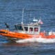 U.S. Coast Guard boat protect Ferry in navigation from Manhattan to Staten Island on Hudson River