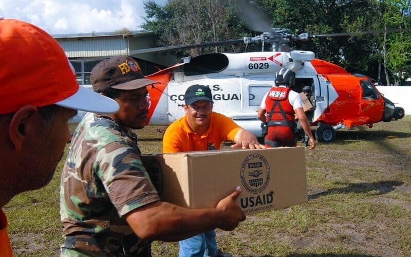 USAID packages are delivered by United States Coast Guard personnel. By United States Coast Guard - flickr.com, Public Domain, via Wikimedia Commons.