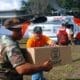 USAID packages are delivered by United States Coast Guard personnel. By United States Coast Guard - flickr.com, Public Domain, via Wikimedia Commons.