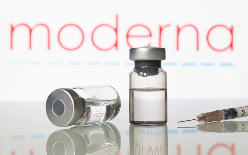 Vials and syringe with Moderna Inc logo