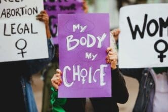 Women demonstrating outdoors from a frontal perspective