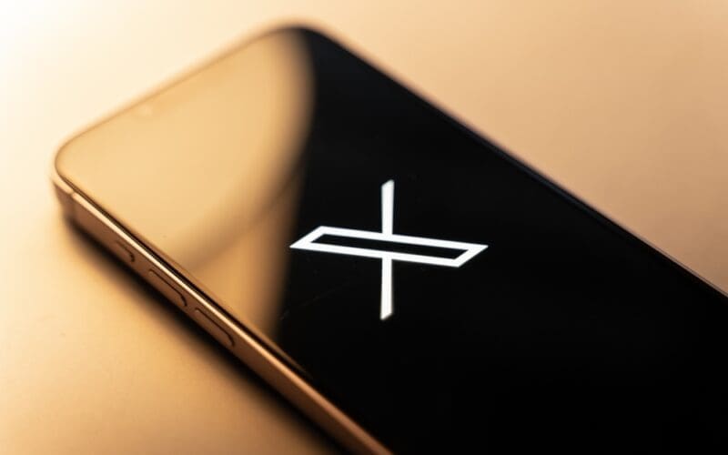 X twitter new logo on phone screen stock image