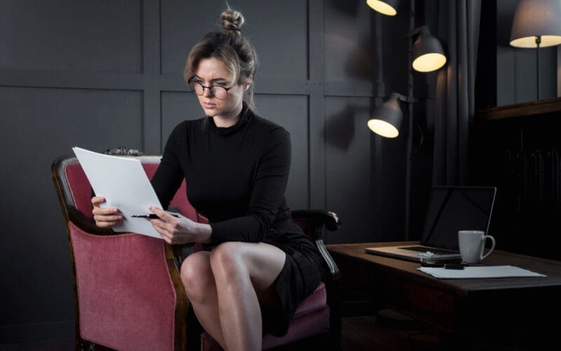 Young woman attentively reviewing her job application