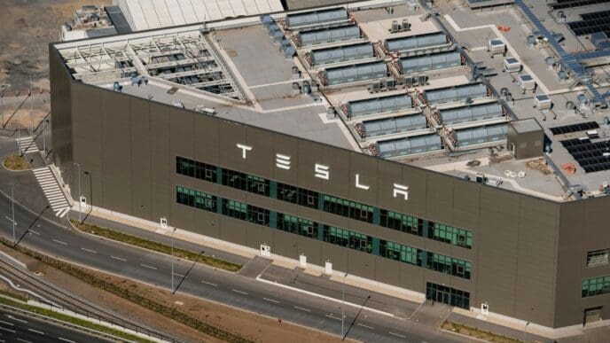 1 May 2024, Berlin, Germany. Aerial view of Tesla Gigafactory in German Grünheide. Huge text logo at entrance of office. The car factory manufactures electric cars.