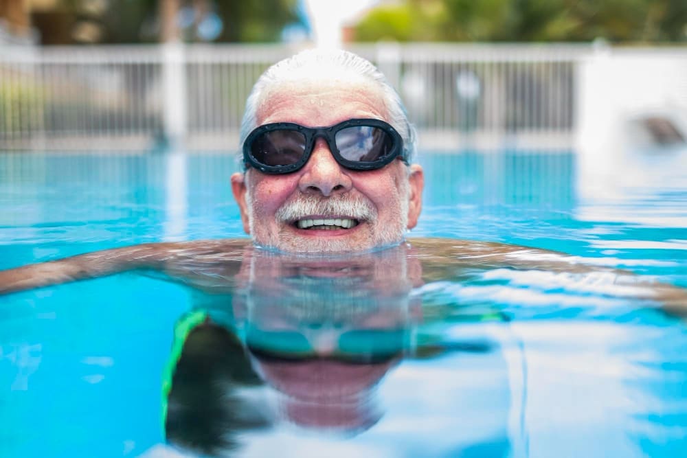A mature man swimming in a pool