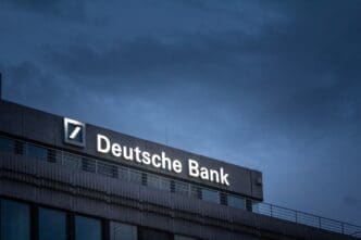 AACHEN, GERMANY - NOVEMBER 8, 2022 Selective blur on a deutsche bank logo on their office for Aachen at night. Deutsche bank is a germany bank specialized in investment and financial services.