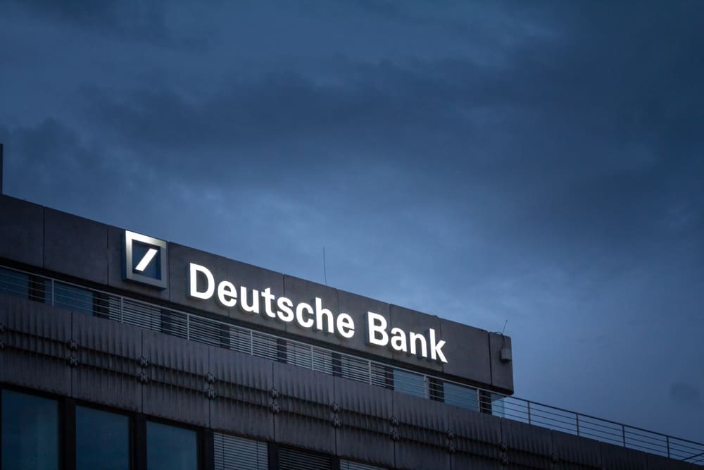 AACHEN, GERMANY - NOVEMBER 8, 2022 Selective blur on a deutsche bank logo on their office for Aachen at night. Deutsche bank is a germany bank specialized in investment and financial services.