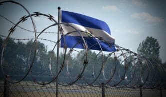 Barbed wire fence and flag of El Salvador - 3d illustration. By Shutterstock.com - PX Media