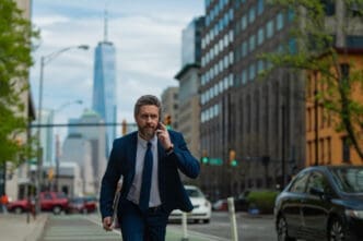 Businessman with phone run in NY Business talk
