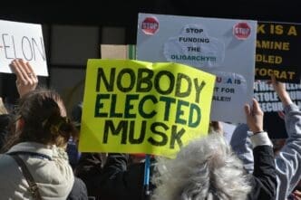 NEW YORK, NEW YORK USA - March 1, 2025: Protest against Elon Musk and DOGE cuts to government spending in front of a Tesla showroom in Manhattan.
