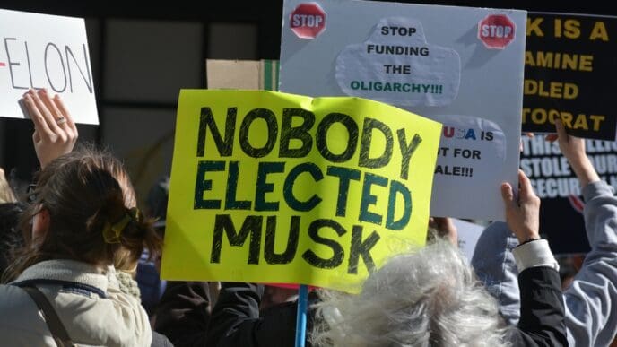 NEW YORK, NEW YORK USA - March 1, 2025: Protest against Elon Musk and DOGE cuts to government spending in front of a Tesla showroom in Manhattan.