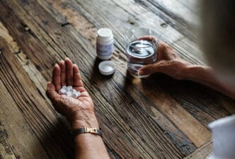 Close up of an adult taking medication
