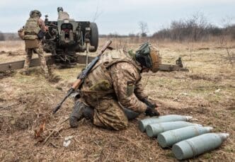 DONETSK REG., UKRAINE - Mar. 21, 2023 War in Ukraine. Artillerymen from the 24th assault battalion Aidar shooting from 122 mm howitzer D-30 into Russian positions near Bakhmut, Donetsk reg, Ukraine