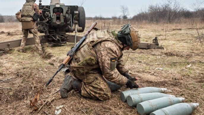 DONETSK REG., UKRAINE - Mar. 21, 2023 War in Ukraine. Artillerymen from the 24th assault battalion Aidar shooting from 122 mm howitzer D-30 into Russian positions near Bakhmut, Donetsk reg, Ukraine