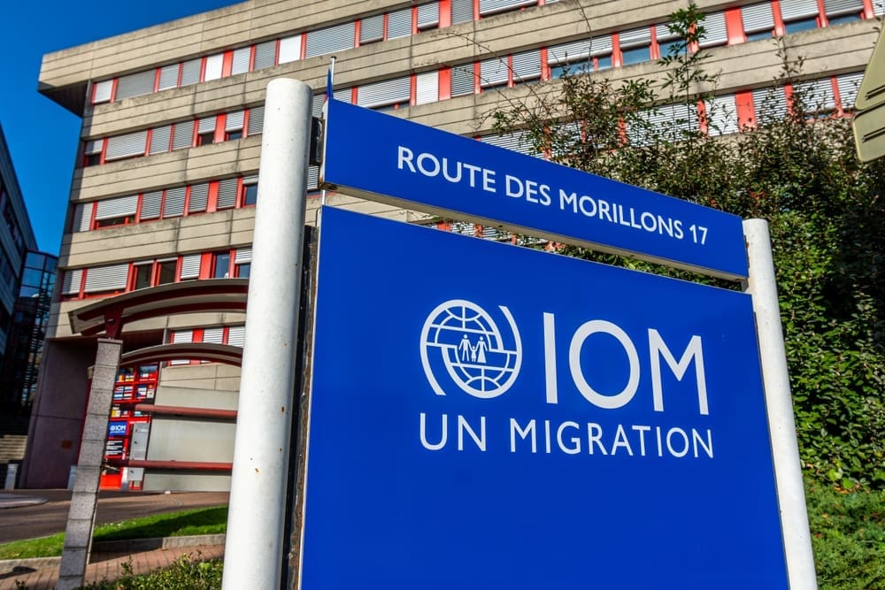 Geneva, Switzerland. Sign at the headquarters of the International Organization for Migration (IOM), the UN intergovernmental agency specializing in migration. By Shutterstock.com - HJBC