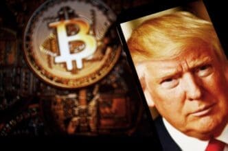 Image of USA President Donald Trump on the smartphone and coins in the background