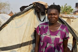 Juba, South Sudan, February 2017. A woman standing in front of her tent at a salesian camp for internally displaced persons (IDPs). Captured during civil war.