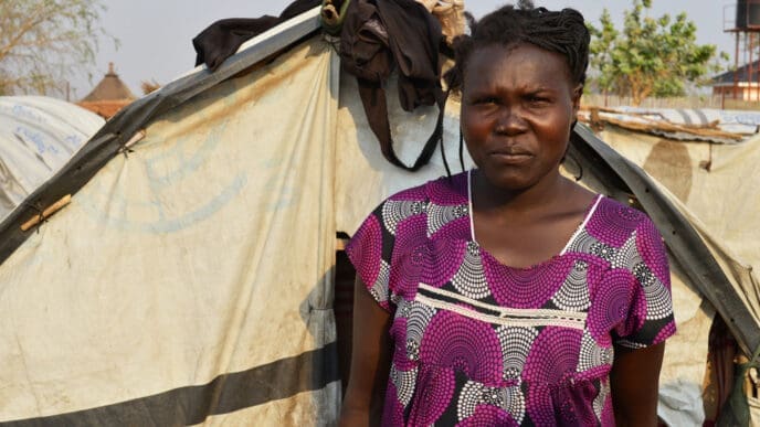 Juba, South Sudan, February 2017. A woman standing in front of her tent at a salesian camp for internally displaced persons (IDPs). Captured during civil war.