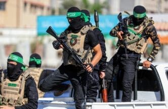 Masked members of the al-Qassam Brigades, the military wing of Hamas, during a march on the 8th anniversary of the kidnapping of the Israeli soldier Shaul Aron in 2014, Gaza City, on July 20, 2022