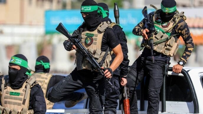 Masked members of the al-Qassam Brigades, the military wing of Hamas, during a march on the 8th anniversary of the kidnapping of the Israeli soldier Shaul Aron in 2014, Gaza City, on July 20, 2022