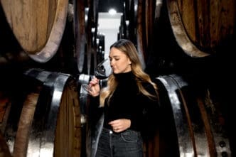 Medium shot woman tasting wine