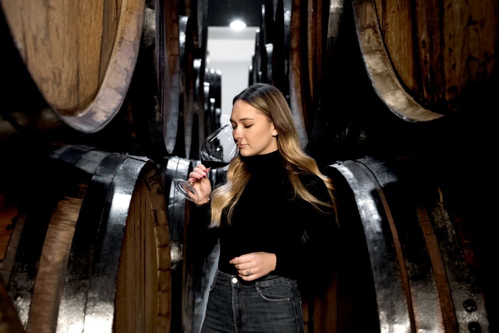 Medium shot woman tasting wine