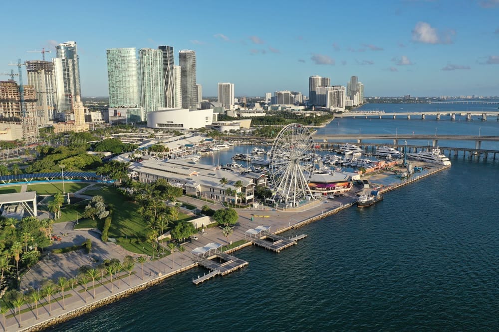 Miami, Florida - November 26, 2020 - Aerial view of Bayside Marketplace, City of Miami Marina and Miami skyline on sunny autumn morning. By Shutterstock.com - Francisco Blanco