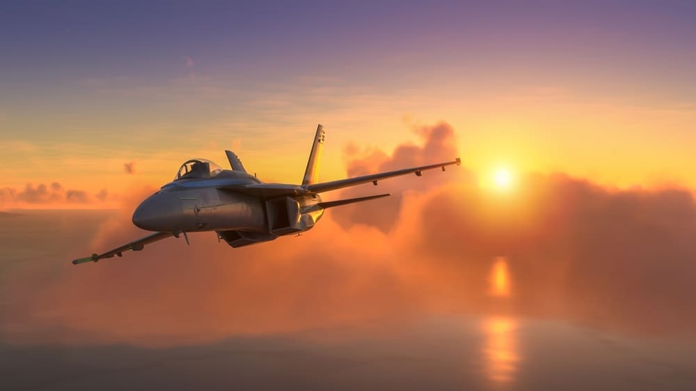 Militar aircraft over the amazing sunset. By Shutterstock - Miguel Lagoa