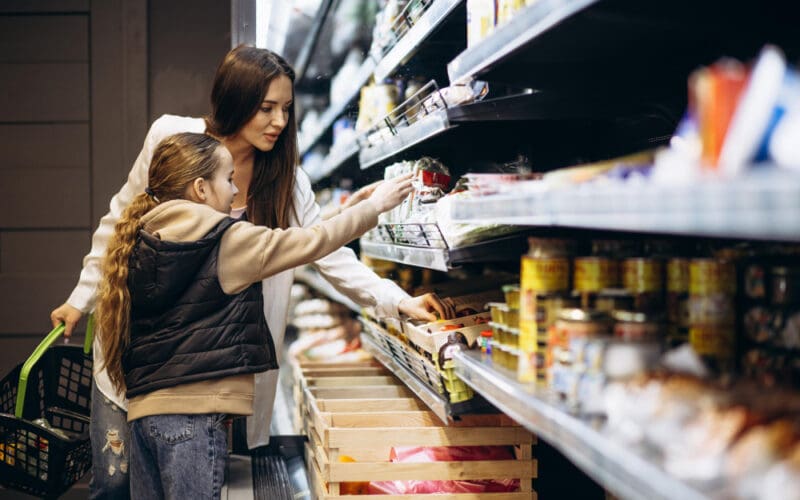 Mother with daughter shopping at grocery store
