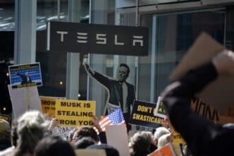 NEW YORK, NEW YORK USA - March 1, 2025: Protest against Elon Musk and DOGE cuts to government funding in front of a Tesla showroom in Manhattan.