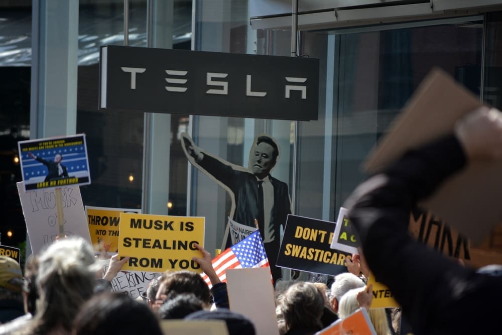 NEW YORK, NEW YORK USA - March 1, 2025: Protest against Elon Musk and DOGE cuts to government funding in front of a Tesla showroom in Manhattan.