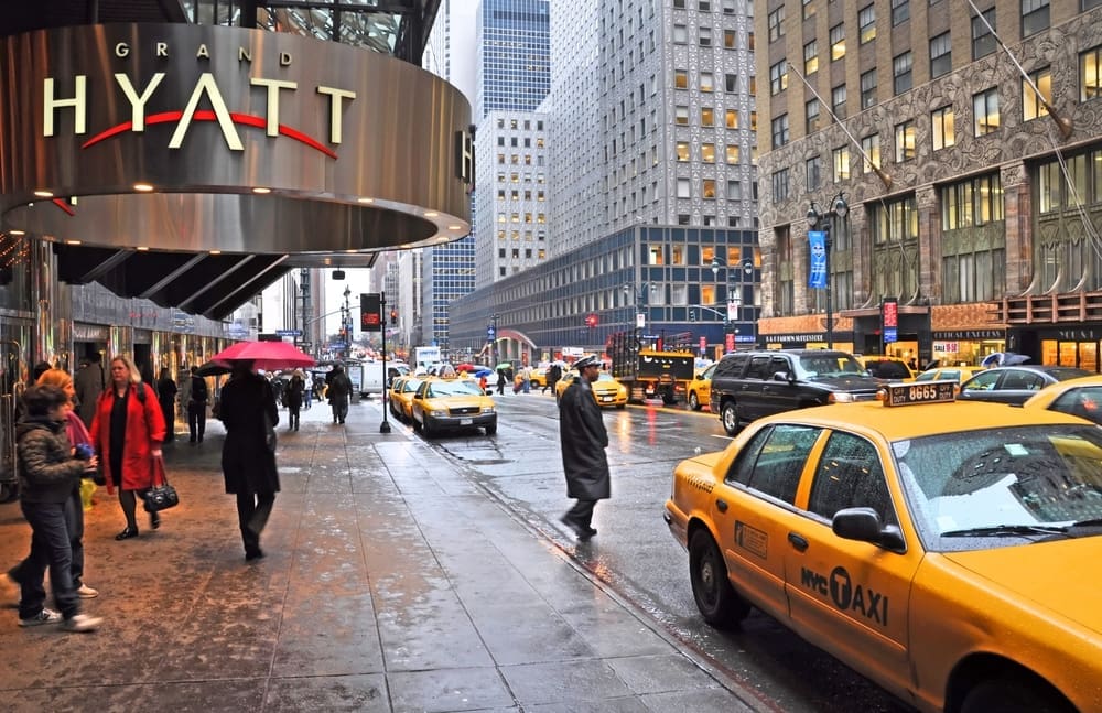 New York, USA - April 06, 2014 Waiting for a taxi outside the Grand Hyatt hotel on East 42nd Street on a wet morning.