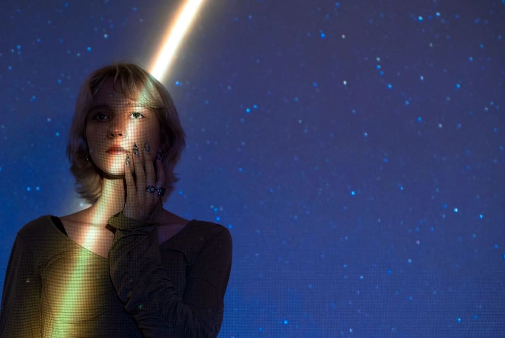 Portrait of a woman with a cosmic backdrop, embodying the midnight concept