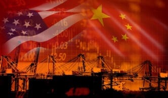 Scenic view of illuminated harbor at night with US vs China flags