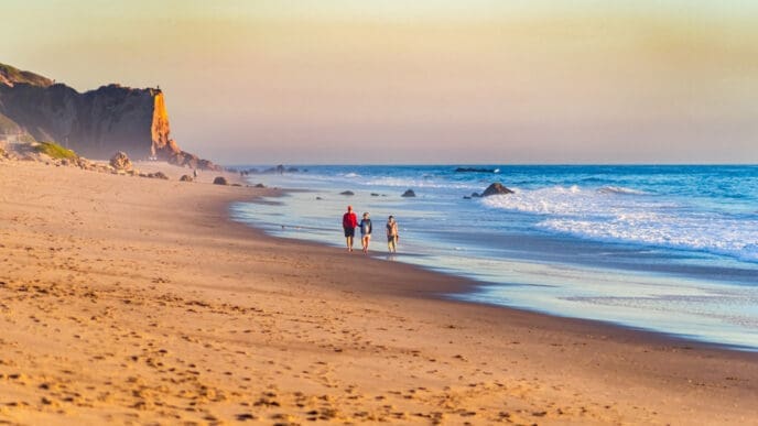 Scenic view of the Zuma Beach in Malibu with people enjoying a walk along the beach