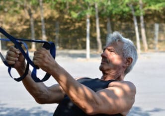 Senior man engaging in TRX training
