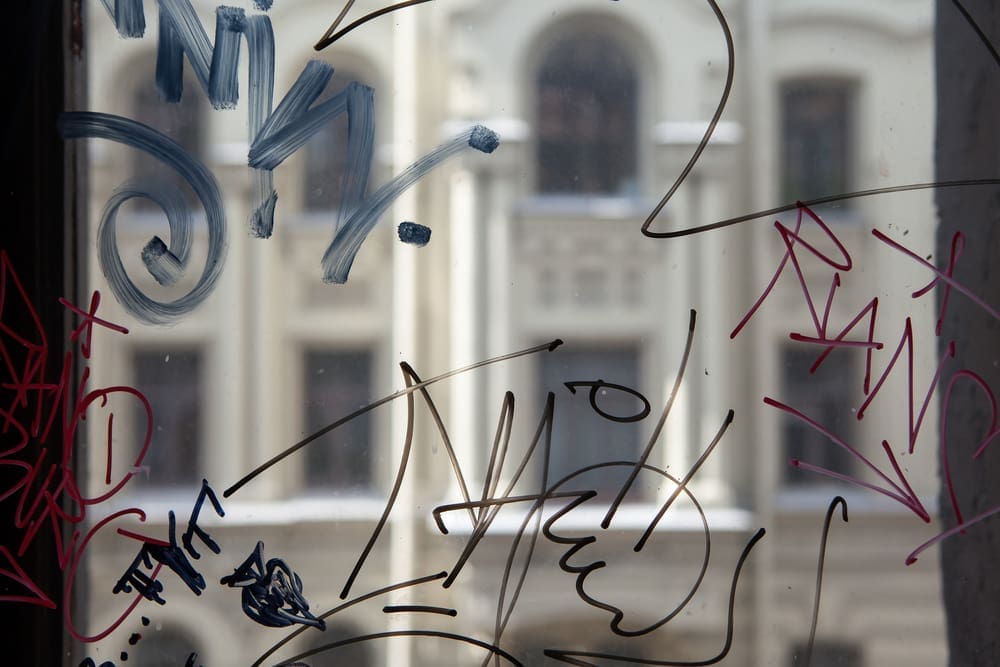 Vandal graffiti on the window of a house