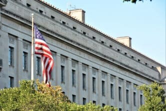 Washington D.C. USA. June 3, 2017. Department of Justice building located in Washington D.C. on a nice sunny day with the United States Flag.