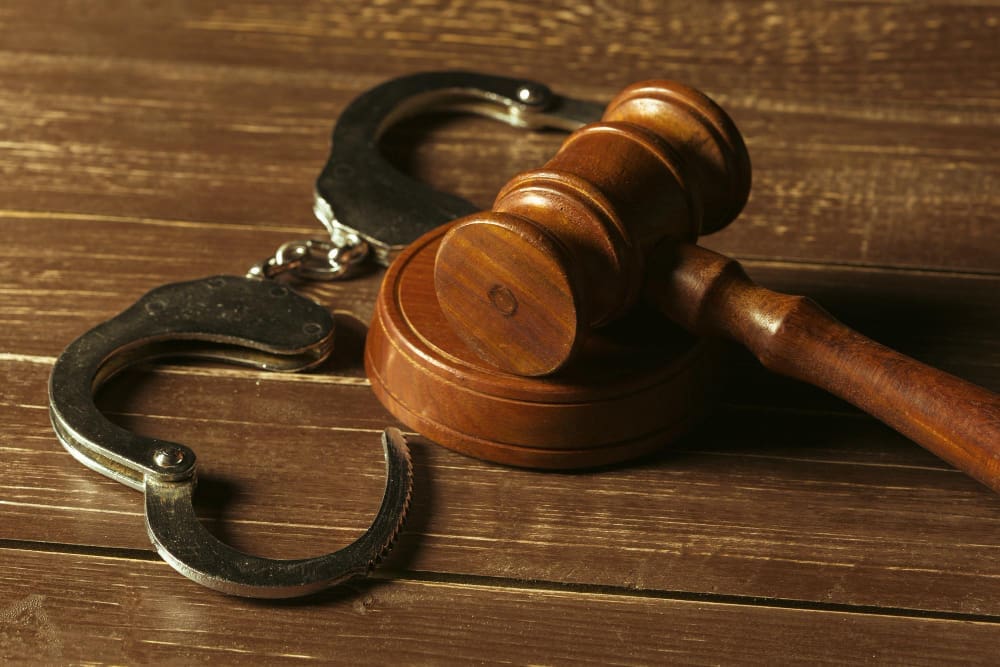 Closeup view of brown wooden mallet of judge and handcuffs
