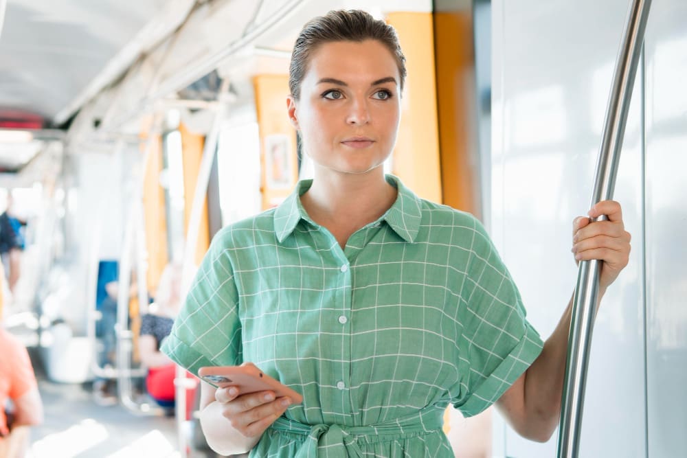 A European woman managing her work in public transportation, viewed from the front