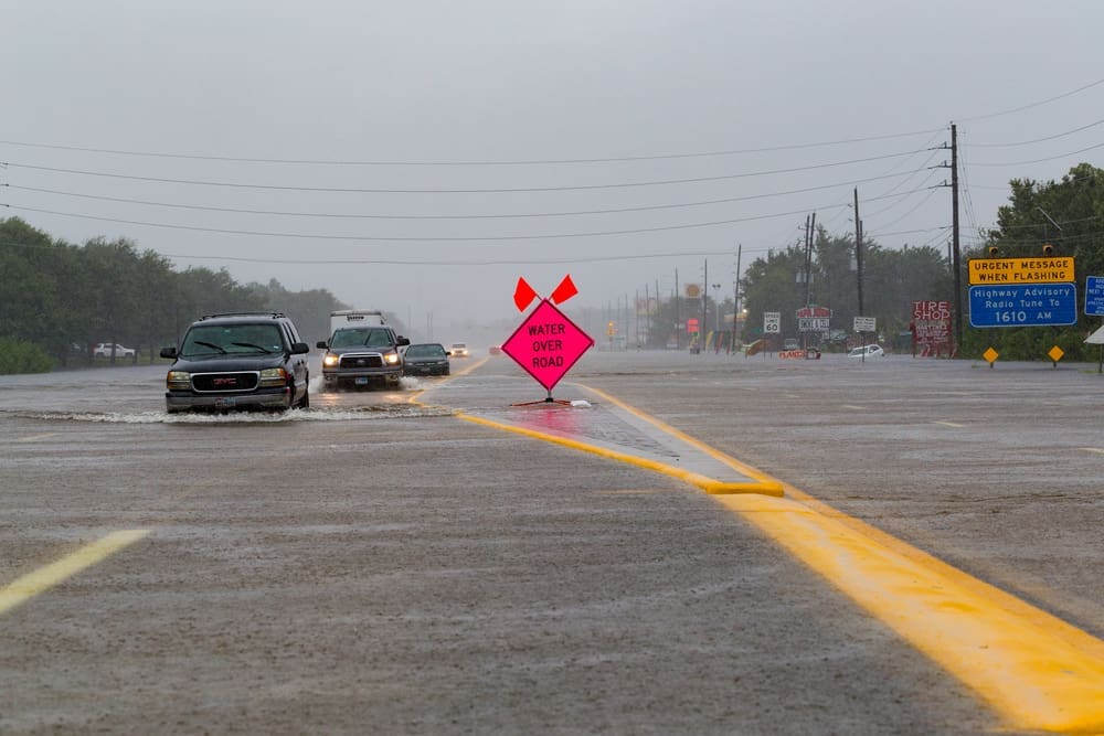 Arcola, Texas - August 28, 2017. Cars drive on flooded State Highway 6. Heavy rains caused many flooded areas in Houston and its suburbs. By Shutterstock - Michelmond