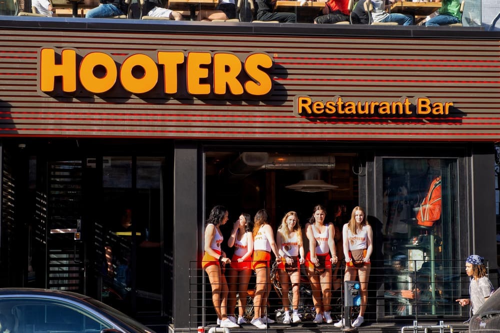 Montreal, Canada - May 27, 2017: Hooters girls at the window of the restaurant on the trendy Crescent St that opened in March of 2017. It is part of a US based casual dining chain