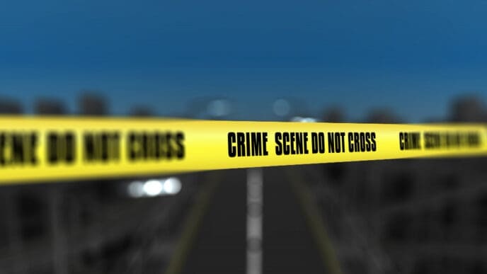 Crime scene tape against blurred city background