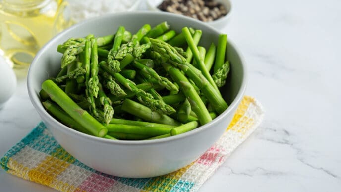 Fresh green asparagus in bowl